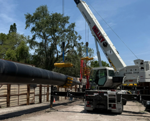 The completed pipe string is moved into place to begin pulling it through the tunnel.